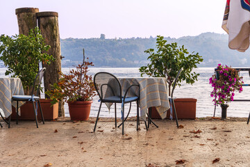 Landscape with a lonely round table with chair by the lake, nobody, riverside