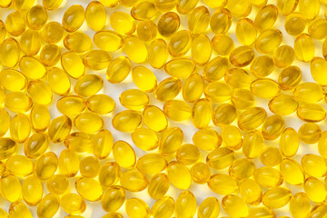 Yellow transparent pills on a white background. Pills with vitamin D3