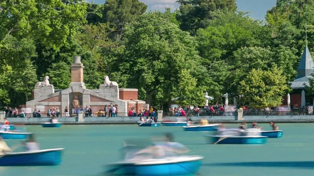 Tourists on boats at lake near Monument to Alfonso XII timelapse in the Parque del Buen Retiro - Park of the Pleasant Retreat in Madrid, Spain