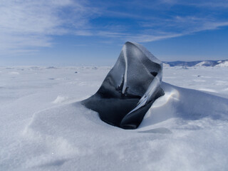 fancifully frozen ice of lake baikal on a sunny day. Siberia Russia