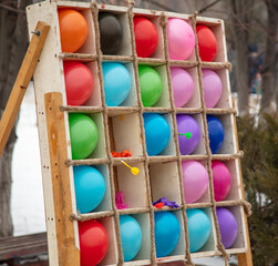 Multi-colored balls to hit with a dart.