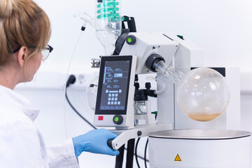 Chemist extracting cbd with rotavapor in laboratory