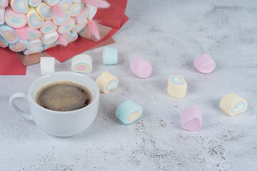 a cup of coffee on the background of sweets Marshmallows, close-up.Holiday concept, congratulations.