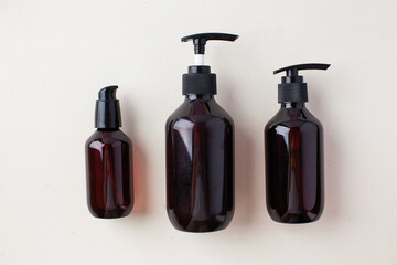 Three different brown bottles with natural organic cosmetics products. Natural zero waste skin body care concept