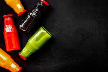vegetable and fruit juice in bottles for diet drink on black background top view mock up