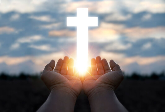 Silhouette A Man Use Hand Holding Wooden Cross With Sunset Backgrounds, Religion Concept, International Prayer Day.	