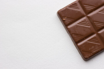 bar of chocolate close on white background