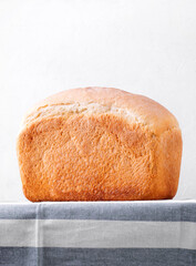 Loaf of wheat bread for toasts on the kitchen table