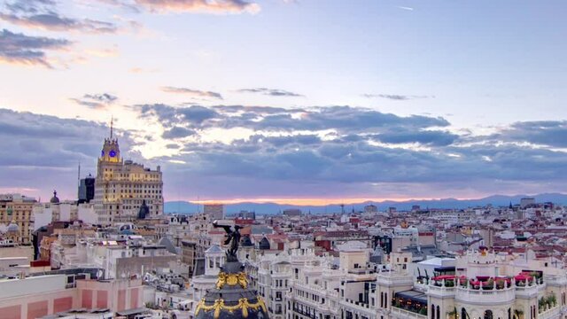 Panoramic aerial view of Gran Via timelapse before sunset, main shopping street in Madrid Skyline Old Town Cityscape, Metropolis Building, capital of Spain, Europe