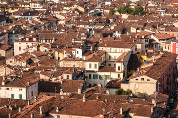 Fototapeta na wymiar Top view of old roofs with tiles, historic part of the city of Brescia, Italy