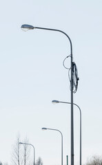 Light poles that are not connected to the electrical network stand along the road, street lighting.