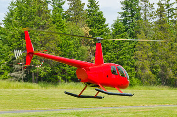a red helicopter and green forest © karamysh