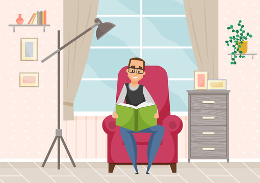 Adult man in glasses reading book sitting in armchair in cozy livingroom interior, resting at home