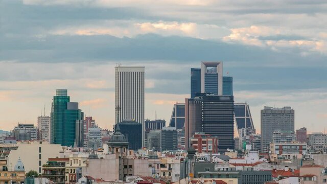 Madrid Skyline at sunset timelapse with some emblematic buildings and towers, part of the Cuatro Torres Business Area and also a side of Santiago Bernabeu Stadium.