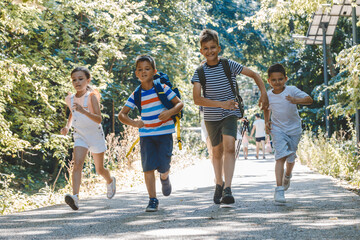 Obraz premium Group of school kids.They're running at the park and having fun. 
