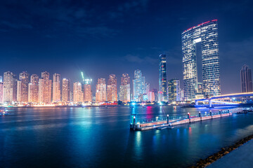 Fototapeta premium Numerous hotels and residential buildings and office business centers on the seashore in Dubai, United Arab Emirates. The concept of real estate prices and tourism