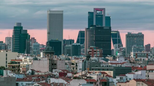 Madrid Skyline at sunset timelapse with some emblematic buildings and towers, part of the Cuatro Torres Business Area and also a side of Santiago Bernabeu Stadium.