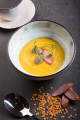 Yellow lentil cream soup served with sausage