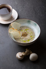 Prepared creamy mushroom soup served on a black table