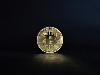 Close up of gold bitcoin on black background with selective focus. Cryptocurrency bitcoin to the future coin.