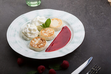 Fried cottage cheese fritters served on a plate