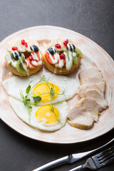 Fresh sweet donuts decorated with fruits and berries served for breakfast