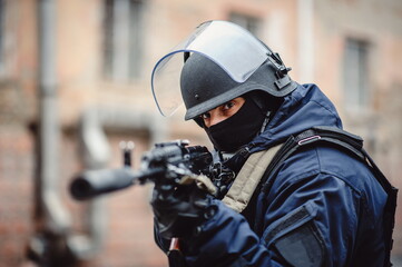 Police. Police officer with weapon and helmet posing on camera. Special Forces
