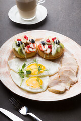 Fresh sweet donuts decorated with fruits and berries served for breakfast