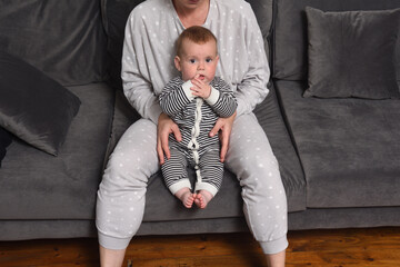 mother and baby sitting together on the sofa