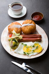 Berliner donuts served with sausage and fried eggs