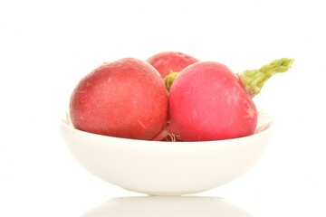 Fresh peeled ripe radish with a ceramic plate, close-up, isolated on white.