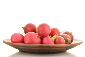 Fresh peeled ripe radish with a ceramic plate, close-up, isolated on white.
