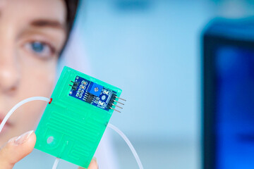 Girl holding polymers Bio-MEMS biomedical microelectromechanical systems / LOC lab-on-a-chip device (concept design)