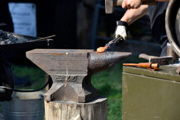 forging damascus steel by hand on the anvil 