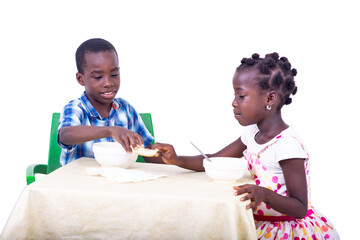 cute little kids having breakfast at the table.