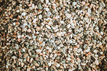 The background is made of stones of different sizes and colors. The texture of natural stones.