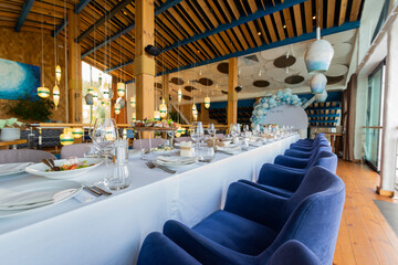 banquet table setting, cold snacks and rolls on the table in a restaurant for a holiday