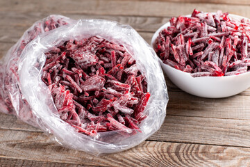 Frozen beet in plastic bag on a table. Frozen food, frozen vegetables.