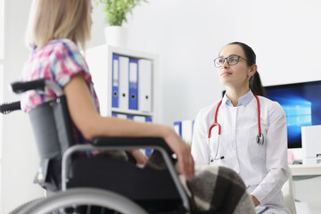 Disabled woman in wheelchair sitting in doctor office