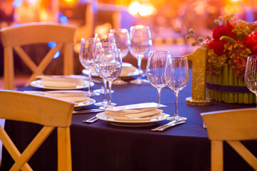 Wine glasses on a served table during a festive event
