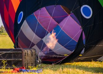 Preparing the balloon for flight. Gas burner with fire inflates a balloon on the ground
