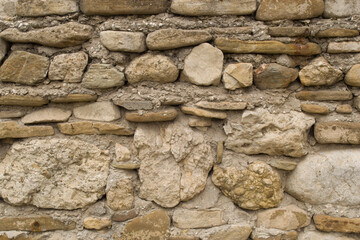 The texture of the ancient wall is made of stones of different sizes. 