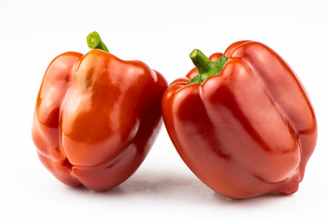 A red, fresh sweet pepper is isolated on a white background.