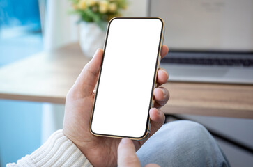 male hand holding golden phone with isolated screen background laptop