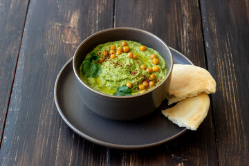 Avocado hummus in a gray bowl. Healthy eating. Vegetarian food.