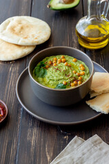 Avocado hummus in a gray bowl. Healthy eating. Vegetarian food.