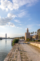 View of the Guadalquivir river and the Torre del Oro in Seville Spain. The Golden Tower on a sunny spring day.
