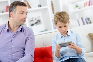 Parent observing childs actions on electronic device