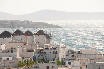 Panoramic view of Mykonos island village (Chora) with traditional Cycladic houses, windmills, and the Aegean Sea in the background