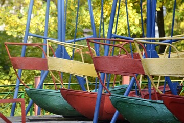 big swing carousel of different colors in autumn in the park without people